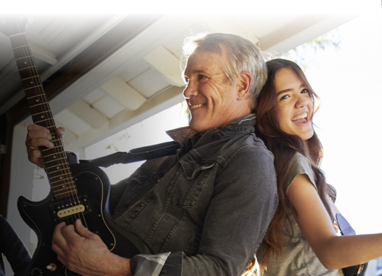 Image of a father and daughter smiling together