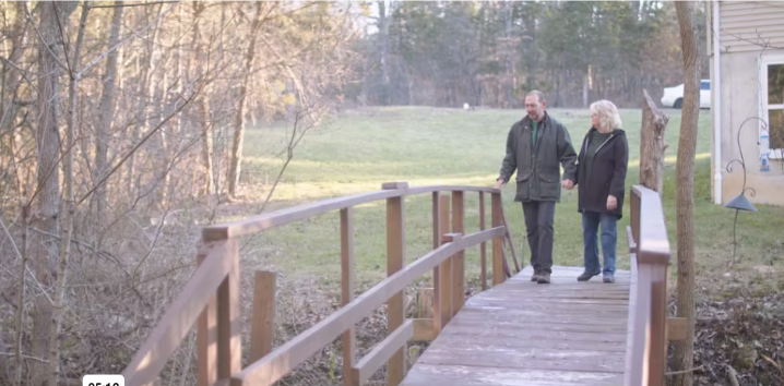 Kerry walking outdoors with a companion on a wooden bridge, featured in her Somatuline® Depot patient story.