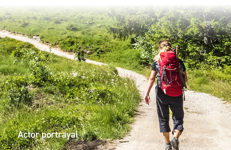 Image of a woman hiking on a path